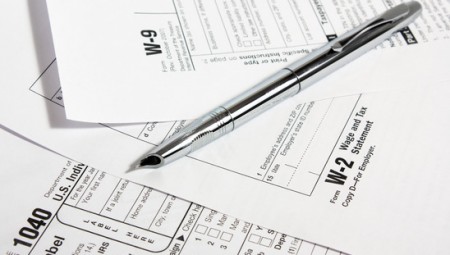metal fountain pen on 1040, w-2, w-9 tax forms tax blog